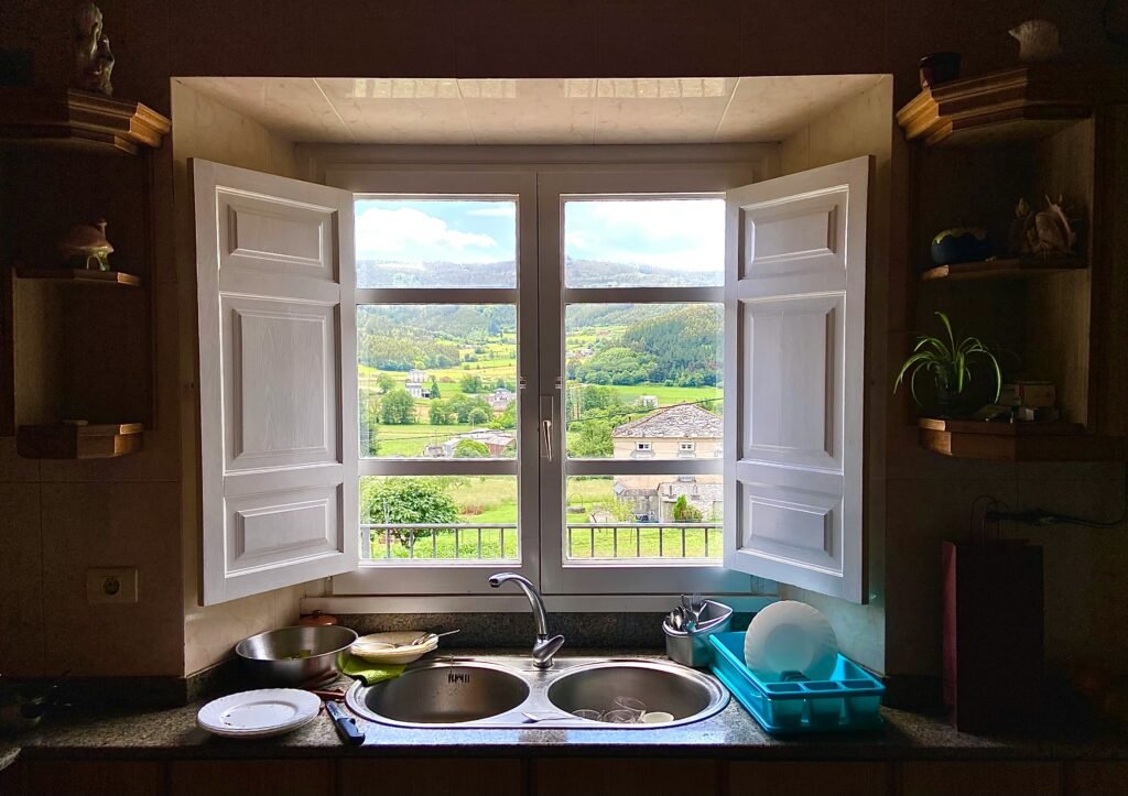 a kitchen with a double sink and open window