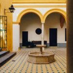 a courtyard with a fountain in the middle of it